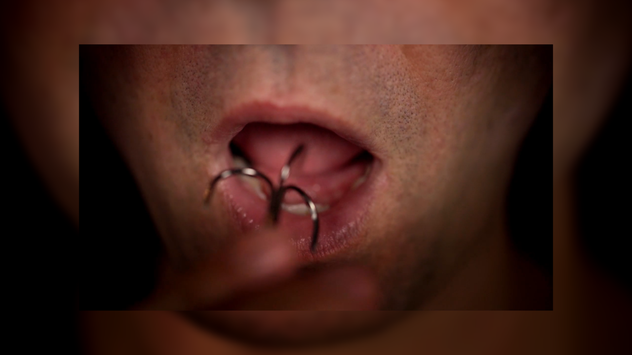 Hook by Eric Ross ~ This trick is so intense, some people can't watch. A roulette game with a fish hook... in your mouth. Screams are practically guaranteed.